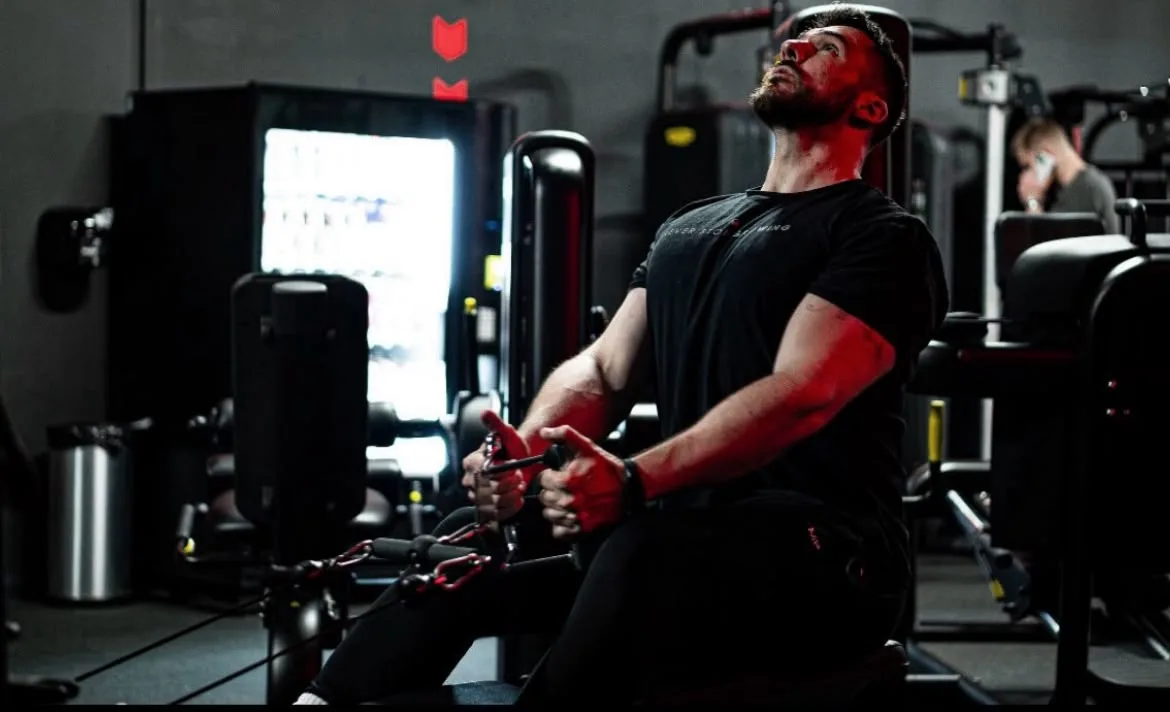 A client working through cable rows in the gym