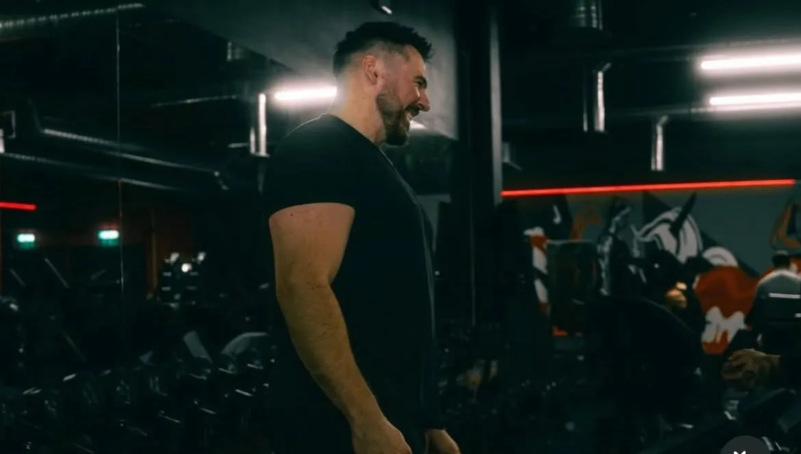 Dan on the gym floor between sets